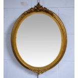 An early 20th Century oval gilt framed wall hanging mirror