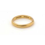 A 22ct yellow gold wedding band,