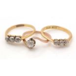 Two three stone diamond rings and a white stone ring,