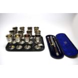 Twelve electroplate chalices; and a Victorian cased carving set.