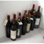 A selection of bottles of red wine.