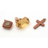 A citrine fob; a porphyry compass pendant and another crucifix pendant.
