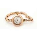A 9ct yellow gold cased wristwatch, the white enamel arabic dial marked Dreadnought,