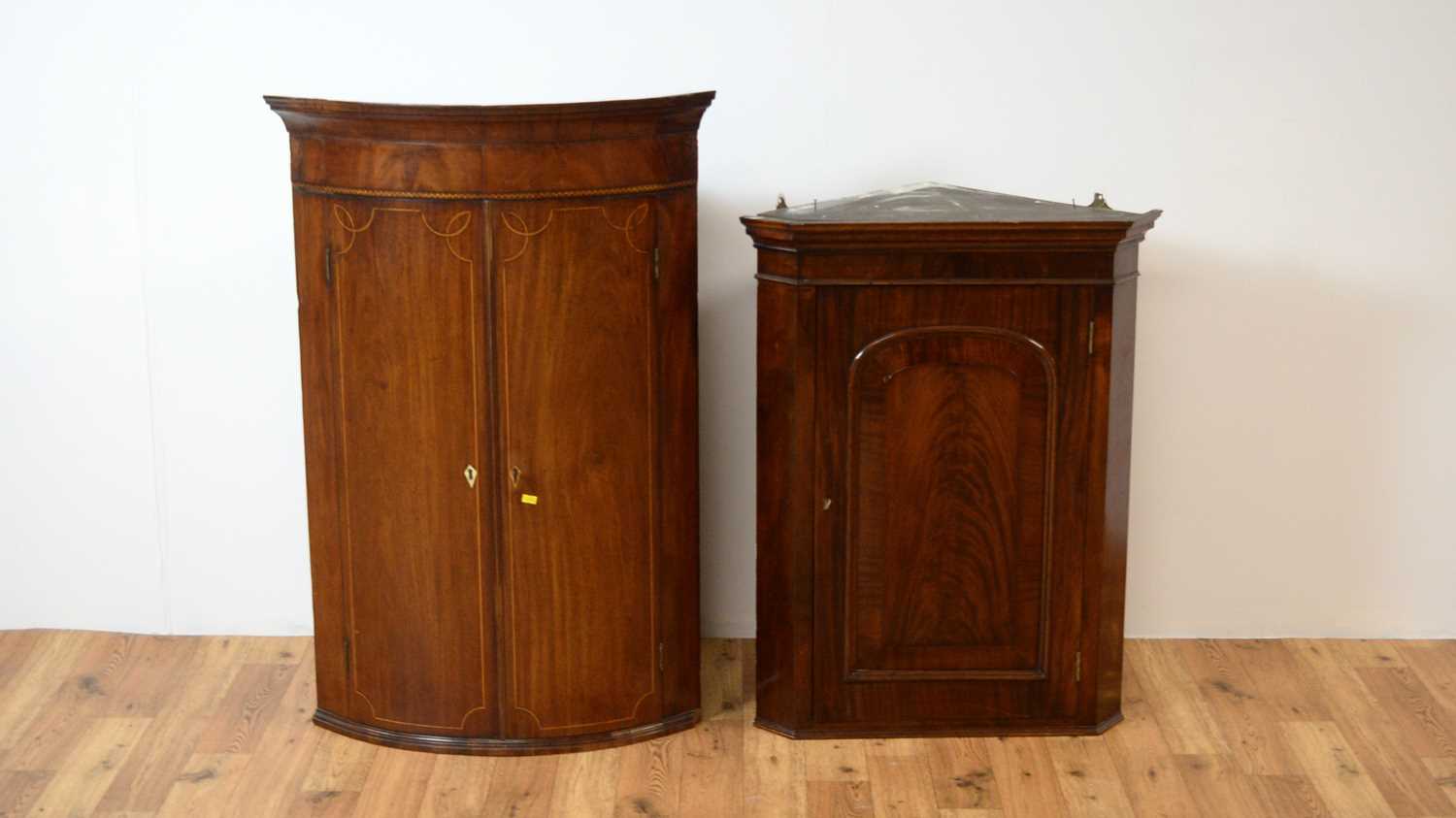 Regency inlaid mahogany bow front corner cupboard, with another,