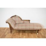 A 19th C Victorian chaise longue upholstered in floral and tartan polychrome fabric