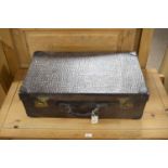 A vintage 20th Century faux snakeskin leather style suitcase.