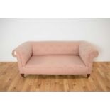 A 19th Century Victorian two person sofa upholstered in pink damask fabric
