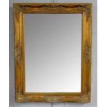 A reproduction gilt framed wall mirror of rectangular form