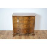 An early 20th Century serpentine mahogany chest of drawers