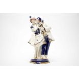 A Royal Dux Vienna ceramic figure group of a couple.