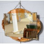 An early 20th Century circa 1930s peach glass mirror of oval form