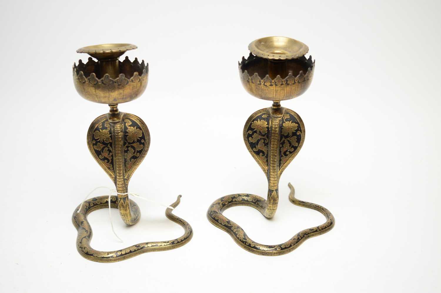 A pair of Eastern brass candlesticks.