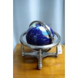 A specimen stone table globe, with abalone and other inset mineral specimens.