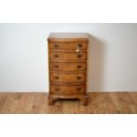 A Georgian-style burr walnut serpentine chest of drawers