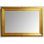 A reproduction gilt framed wall mirror of rectangular form with stepped frame