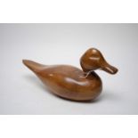 A carved wood decoy duck figure