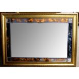 A reproduction gilt framed wall mirror