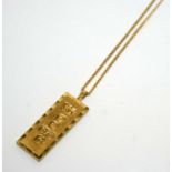 A 9ct yellow gold ingot pendant, on gold chain,