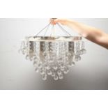 A pair of modern ceiling light fittings, each with crystal lustre drops, by LSE Retail Group.