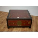 A 20th Century Chinese oriental red lacquer and gilt detailed table of square form,
