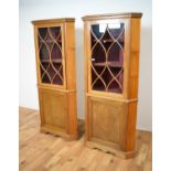 A pair of Georgian style inlaid corner cupboards