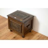 A 20th Century carved oak coal scuttle/purdonium