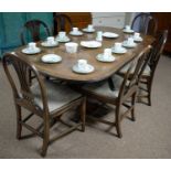 A Georgian style mahogany extendable twin pedestal dining table and six chairs