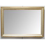 A gilt-framed wall mirror.