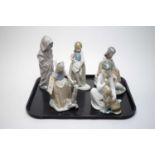 A Lladro figure of Boy with Dog; together with four Nao figures