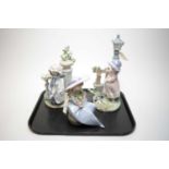 A collection of three Lladro figures of girls, each unboxed