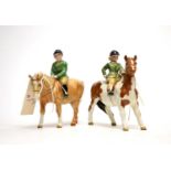 A pair of Beswick figures, comprising: Girl on Pony; and Boy on Pony.