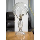 A cut glass table lamp, with silver plated mounts and domed glass shade, wired for electricity