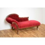 A late 19th century chaise longue upholstered in red velvet fabric