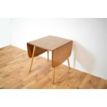 Ercol: a retro vintage mid 20th entury circa 1970's beach and elm dropleaf dining table.