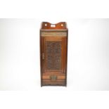 An Art Nouveau carved oak smokers cabinet, with galleried top.