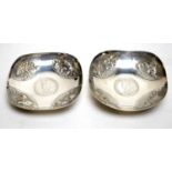 A pair of Indian silver coin set pin dishes.