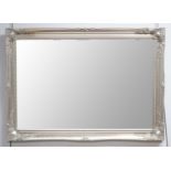A contemporary silvered wall mirror of rectangular form