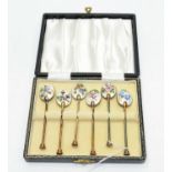 A set of six silver gilt and floral decorated enamel coffee spoons, by William Suckling Ltd,