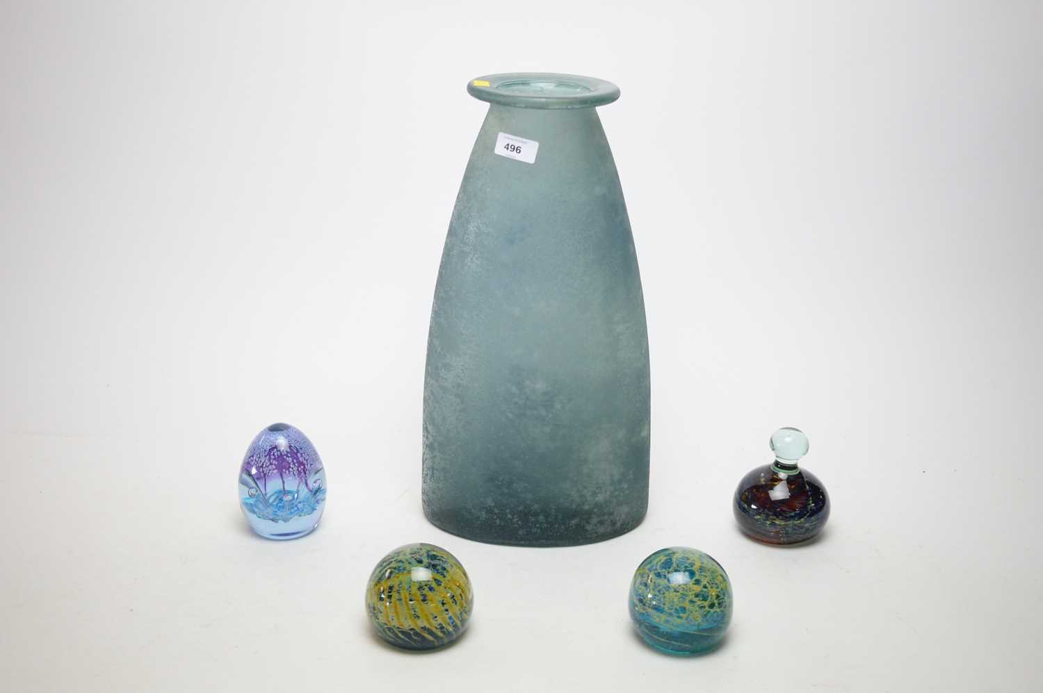 Three Mdina glass paperweights and another paperweight; and an opaque mottled blue glass vase