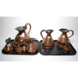 A graduated composite set of seven Victorian copper harvest measure jugs.