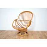 A retro vintage 20th Century swivel easy chair in bamboo and rattan