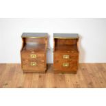 A pair of 20th Century maple veneered leather topped bedside cabinets