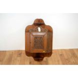 A 20th Century Arts and Crafts style wall hanging corner cabinet,