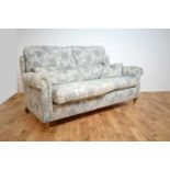 Duresta two-seater sofa and chair upholstered in pale blue floral woven cotton.