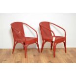 A pair of vibrant red 20th Century children's wicker chairs