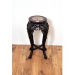 A 20th Century Oriental hardwood marble-topped jardiniere stand