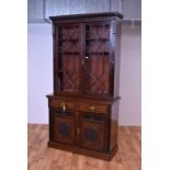An early 20th Century mahogany carved and glazed bookcase