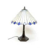 A Tiffany style table lamp, with cream and blue leaded glass style shade,
