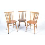 An Ercol 391 'All-Purpose' Windsor chair; and two dining chairs.