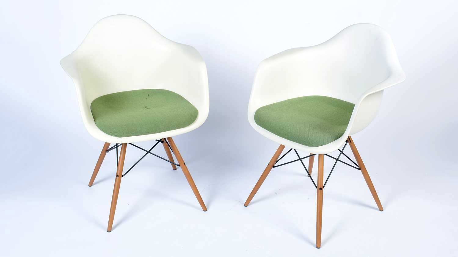 Vitra after a design by Charles and Ray Eames: a pair of white plastic chairs.